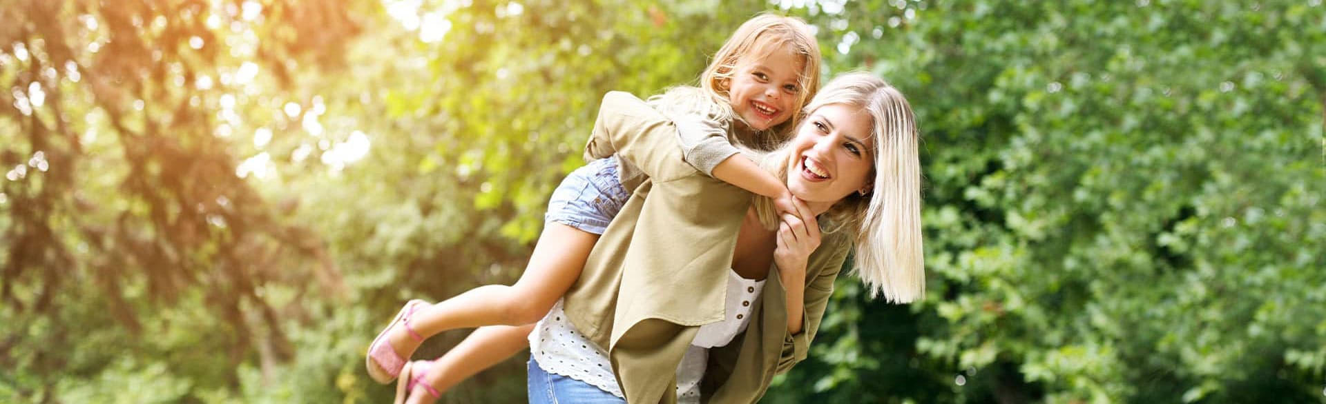 mother playing with her daughter outdoors