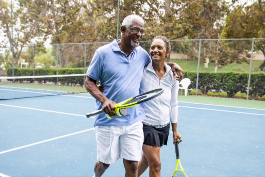 senior couple playing tennis